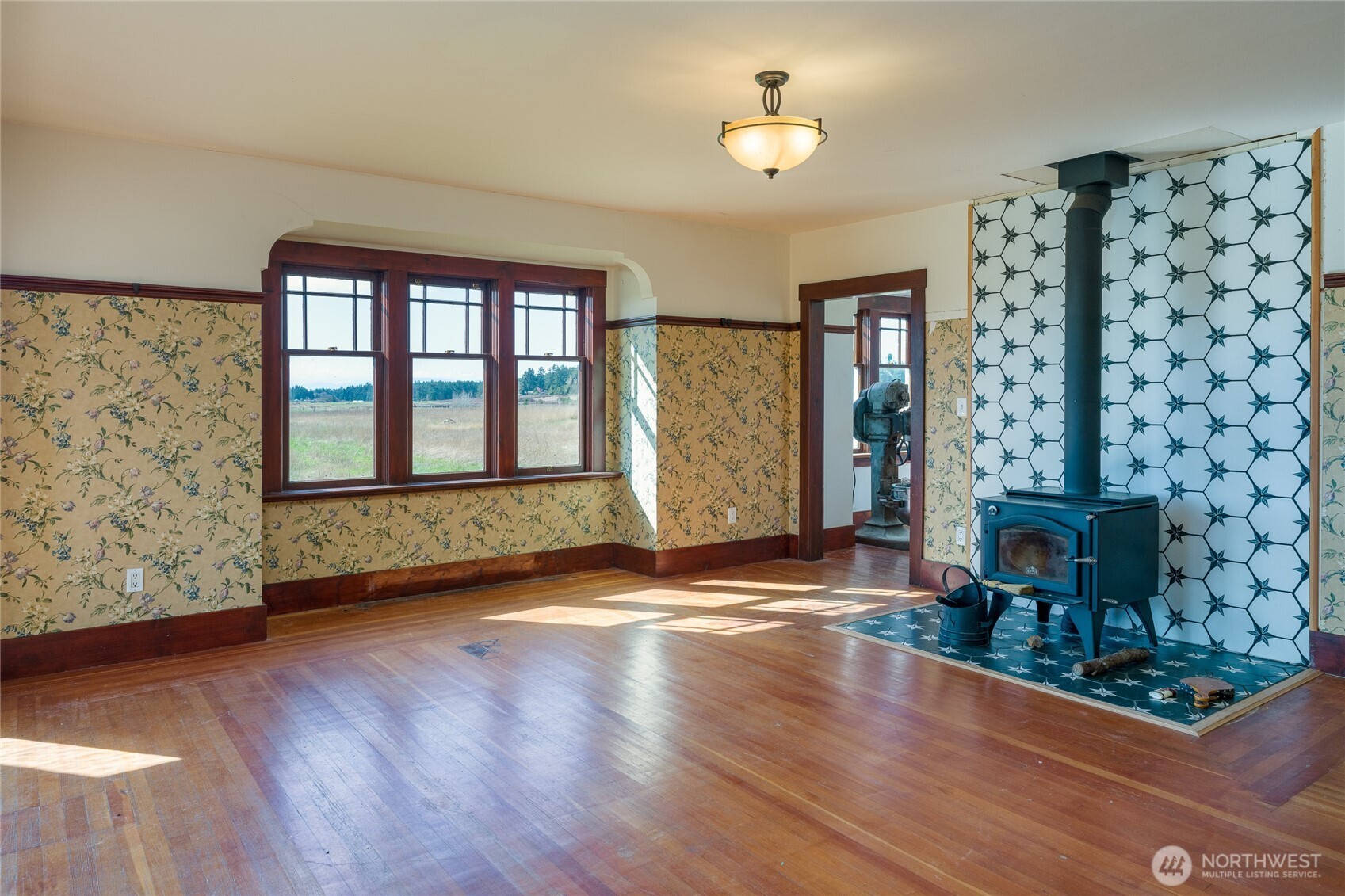 5625 Fisherman Bay Road Lopez Island, WA 98261 - Photo 18 of 40 wooden floor in an empty room with a fireplace