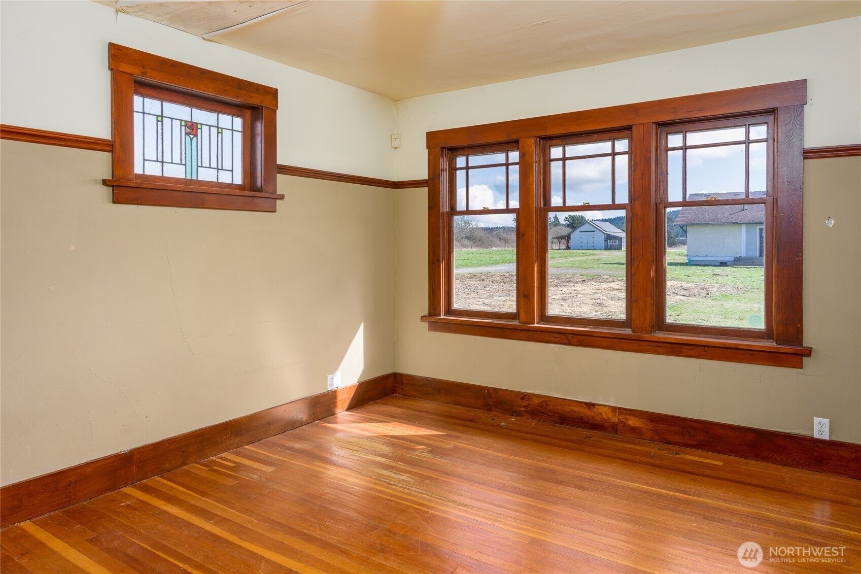 5625 Fisherman Bay Road Lopez Island, WA 98261 - Photo 20 of 40 a view of an empty room with wooden floor and a window