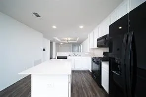 a kitchen with stainless steel appliances a refrigerator stove microwave and cabinets