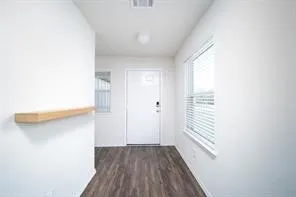 a view of a room with wooden floor