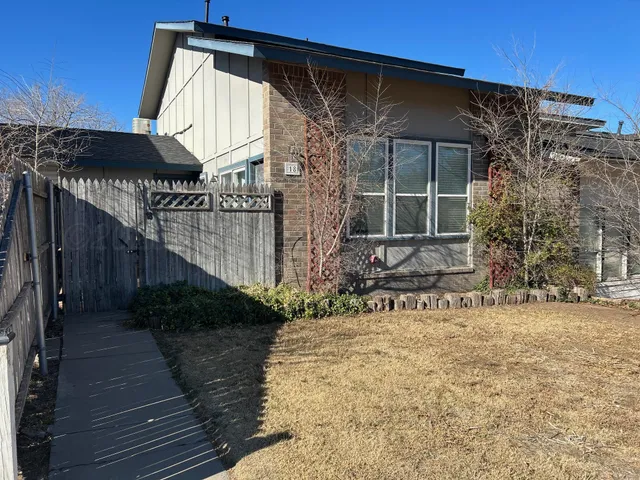 a view of house with wooden fence
