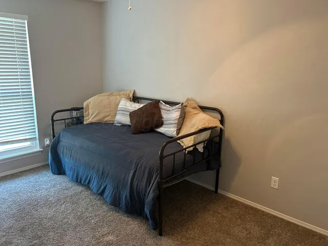 a bedroom with a bed and a window