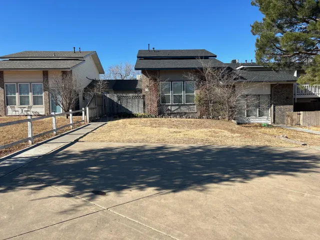 a view of a house with snow on the side of it
