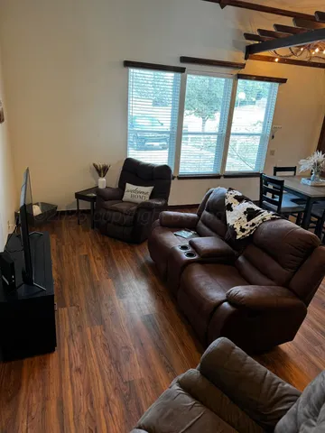 a living room with furniture and a floor to ceiling window