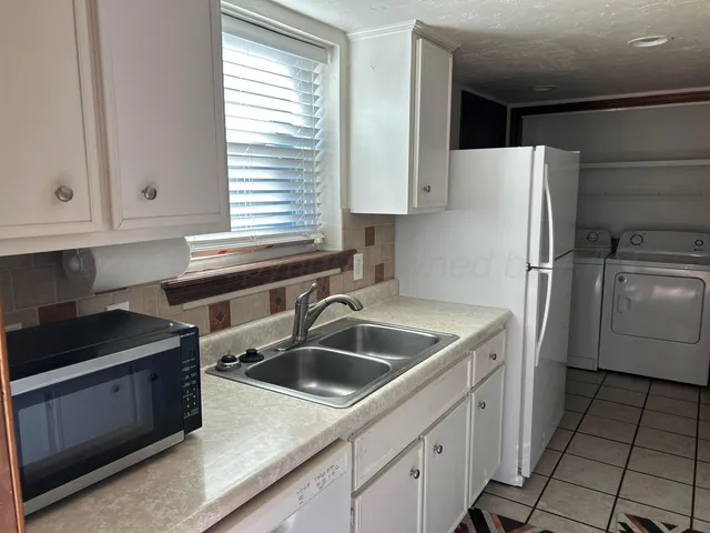 a kitchen that has a sink and a stove