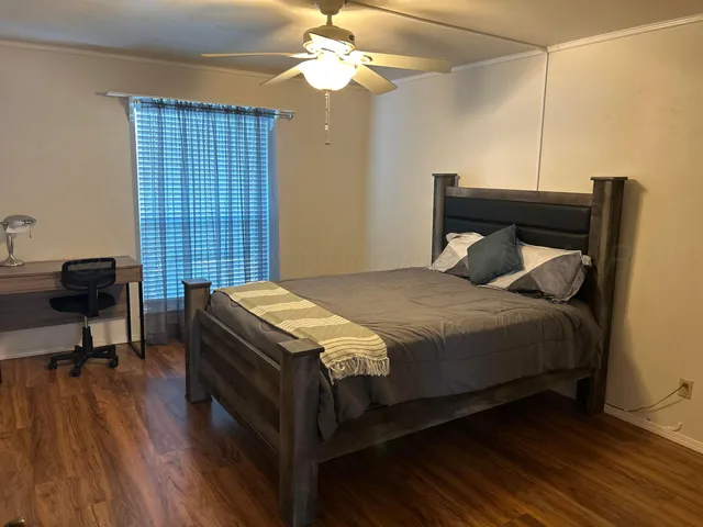a bedroom with a bed and a chandelier