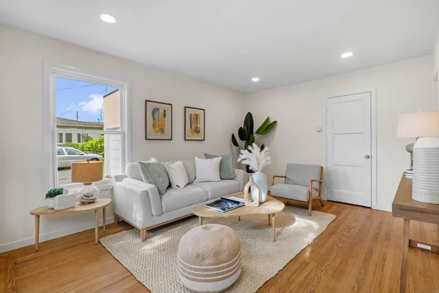 a living room with furniture potted plant and a window