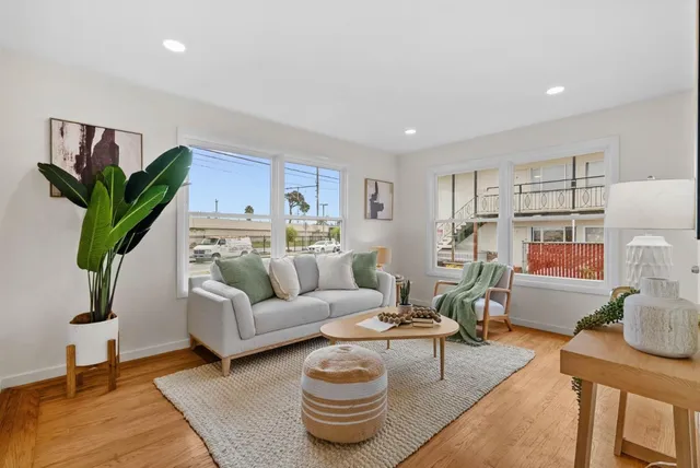a living room with furniture and wooden floor