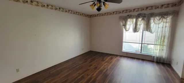 a view of a room with window wooden floor and windows