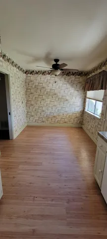a view of wooden floor and windows in a room