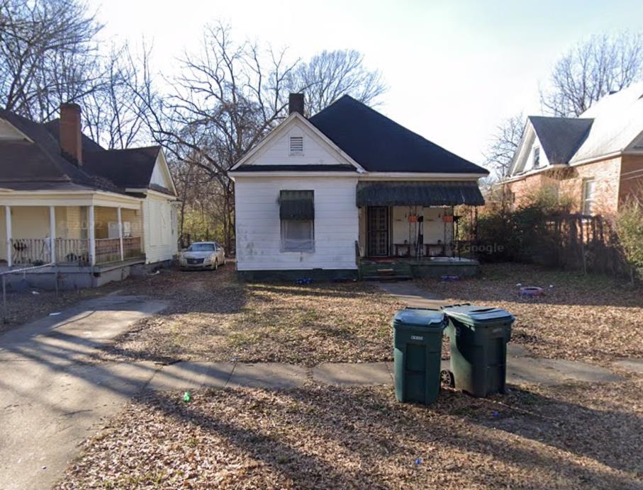 1321 Ridgeway Street Memphis, TN 38106 - Photo 1 of 1 Back of house featuring a porch and a chimney