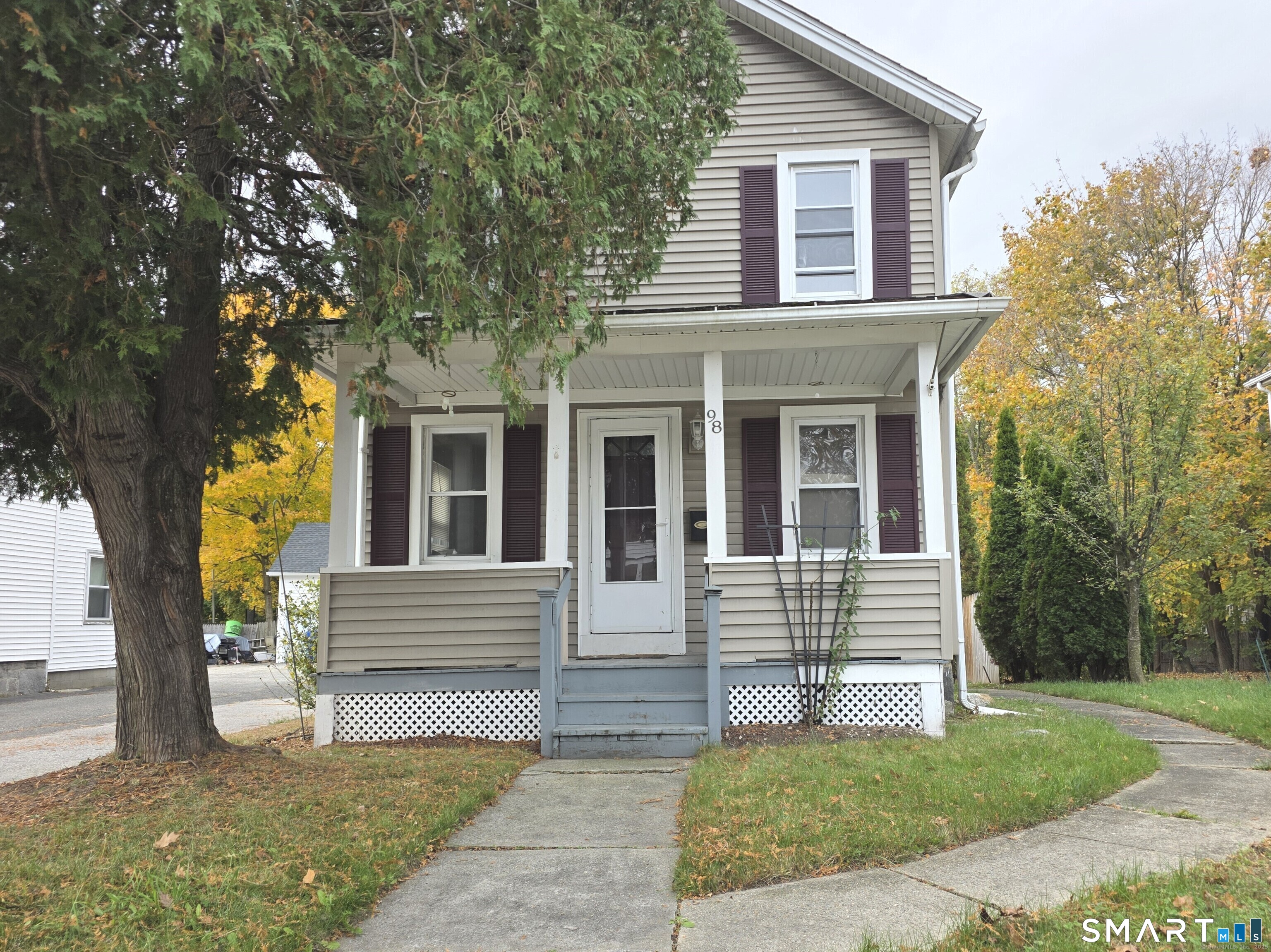 a house that has a tree in front of the house