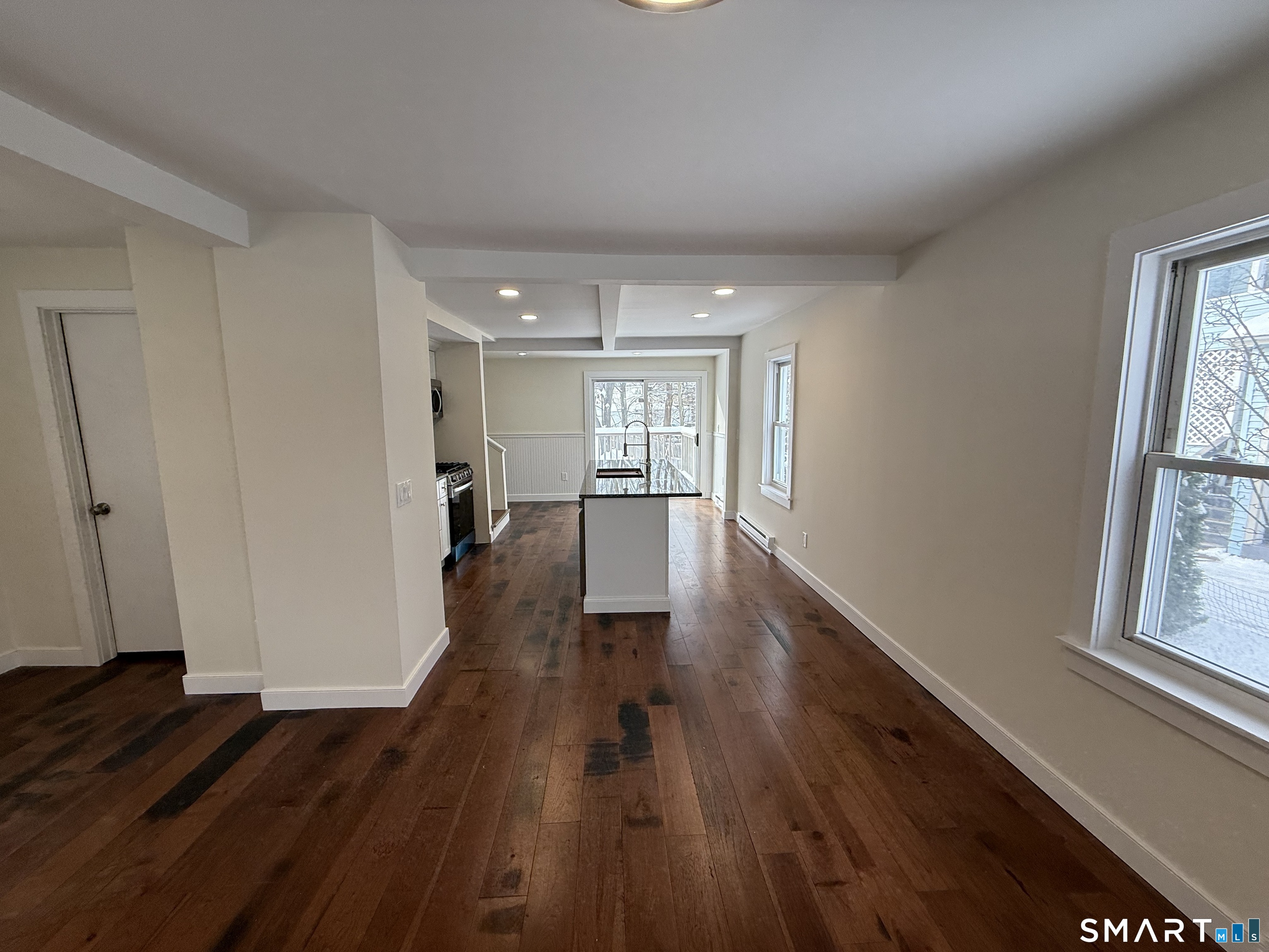 98 East Elm Street Torrington, CT 06790 - Photo 10 of 10 a view of a big room with wooden floor and windows