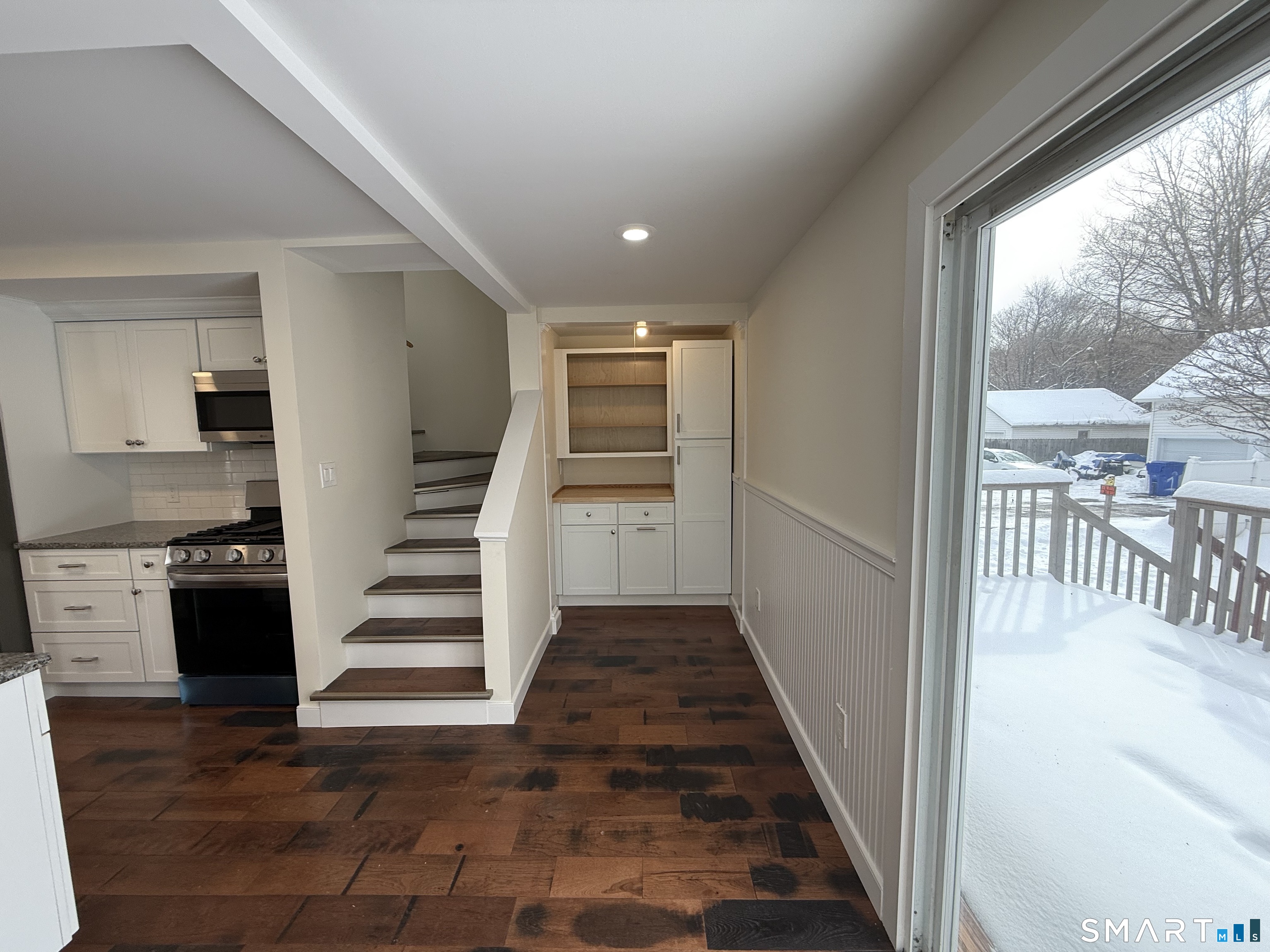 98 East Elm Street Torrington, CT 06790 - Photo 6 of 10 a view of a hallway with wooden floor and windows