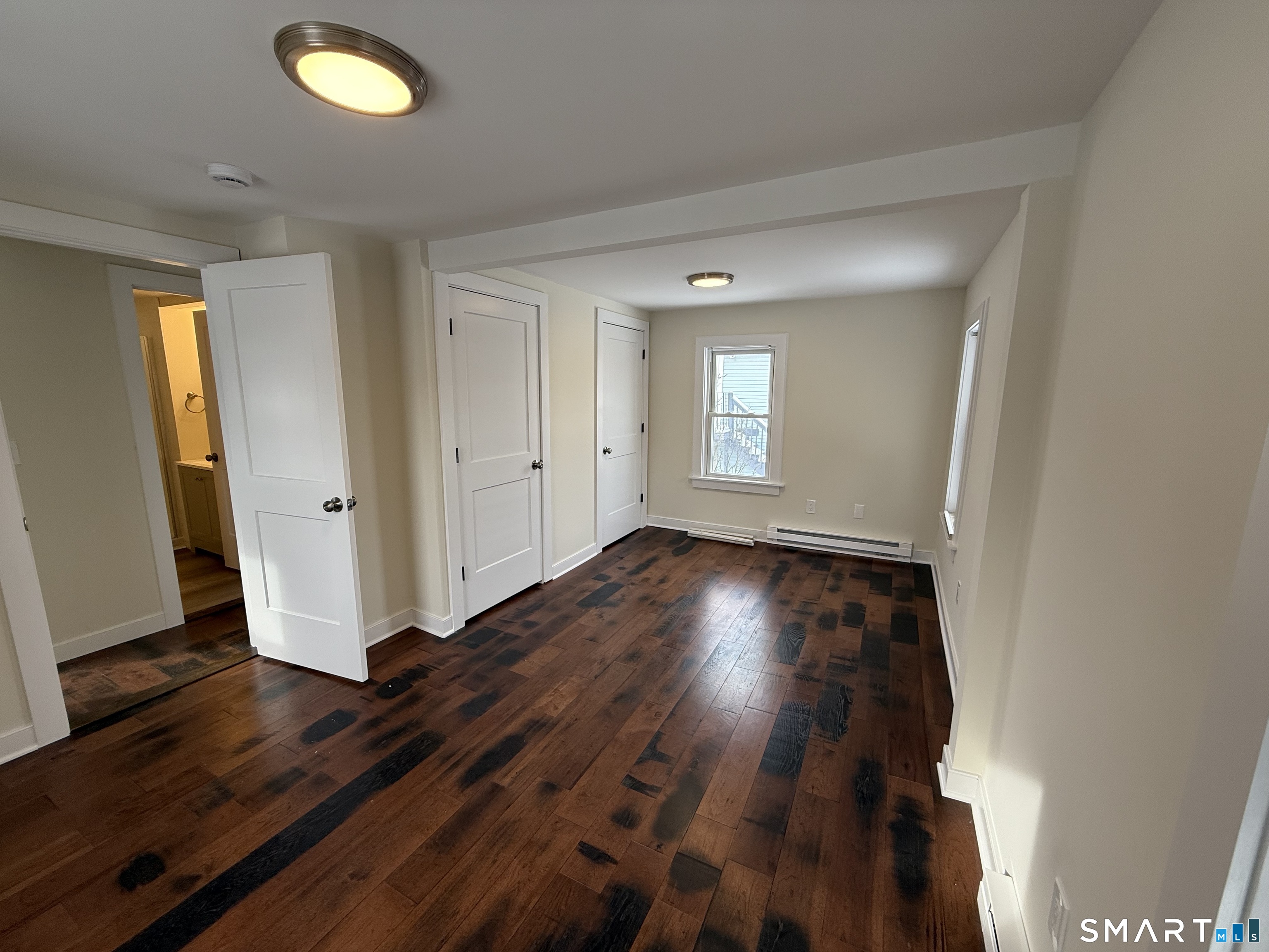 98 East Elm Street Torrington, CT 06790 - Photo 7 of 10 an empty room with wooden floor and windows