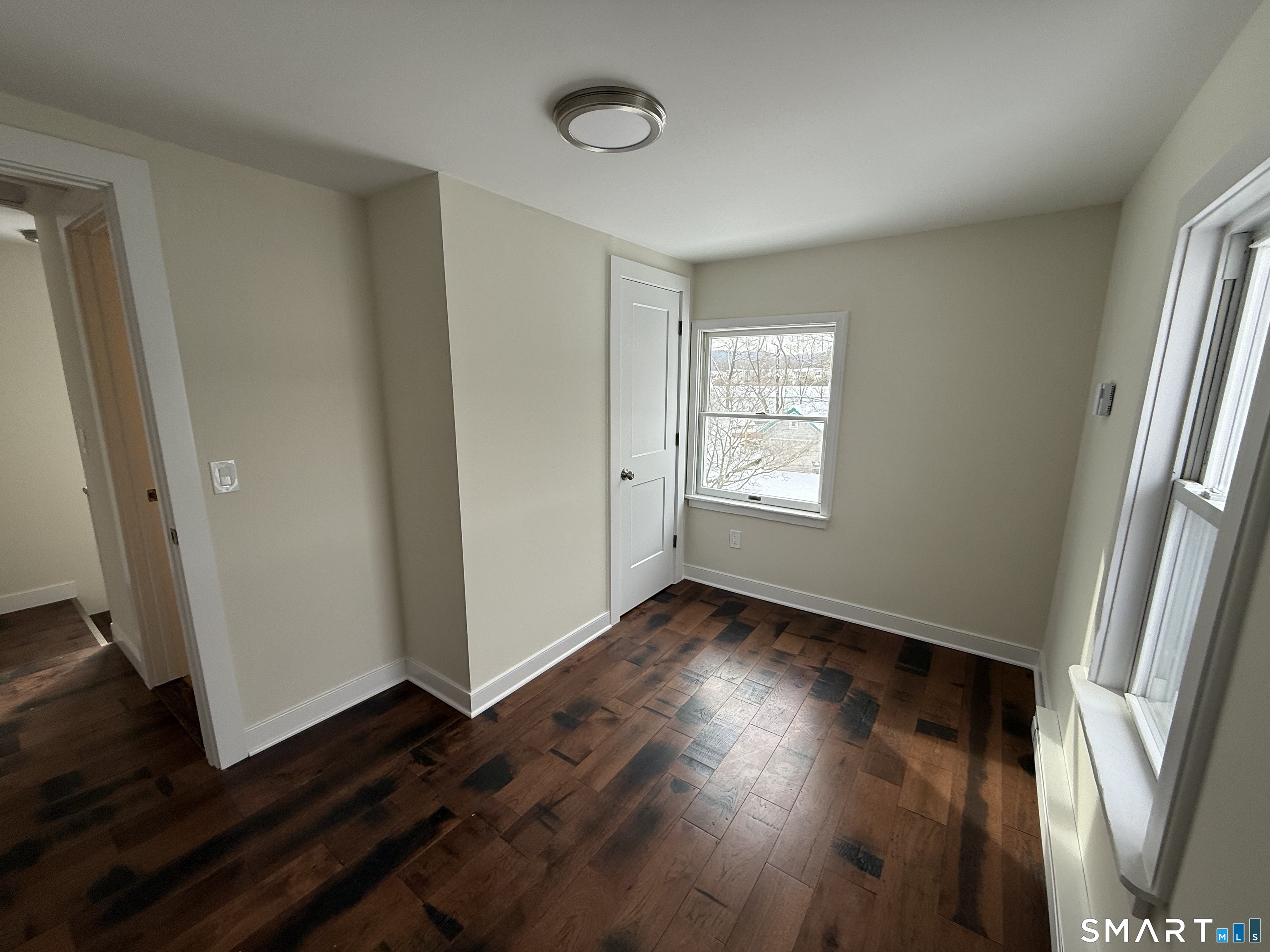 98 East Elm Street Torrington, CT 06790 - Photo 8 of 10 an empty room with wooden floor and windows