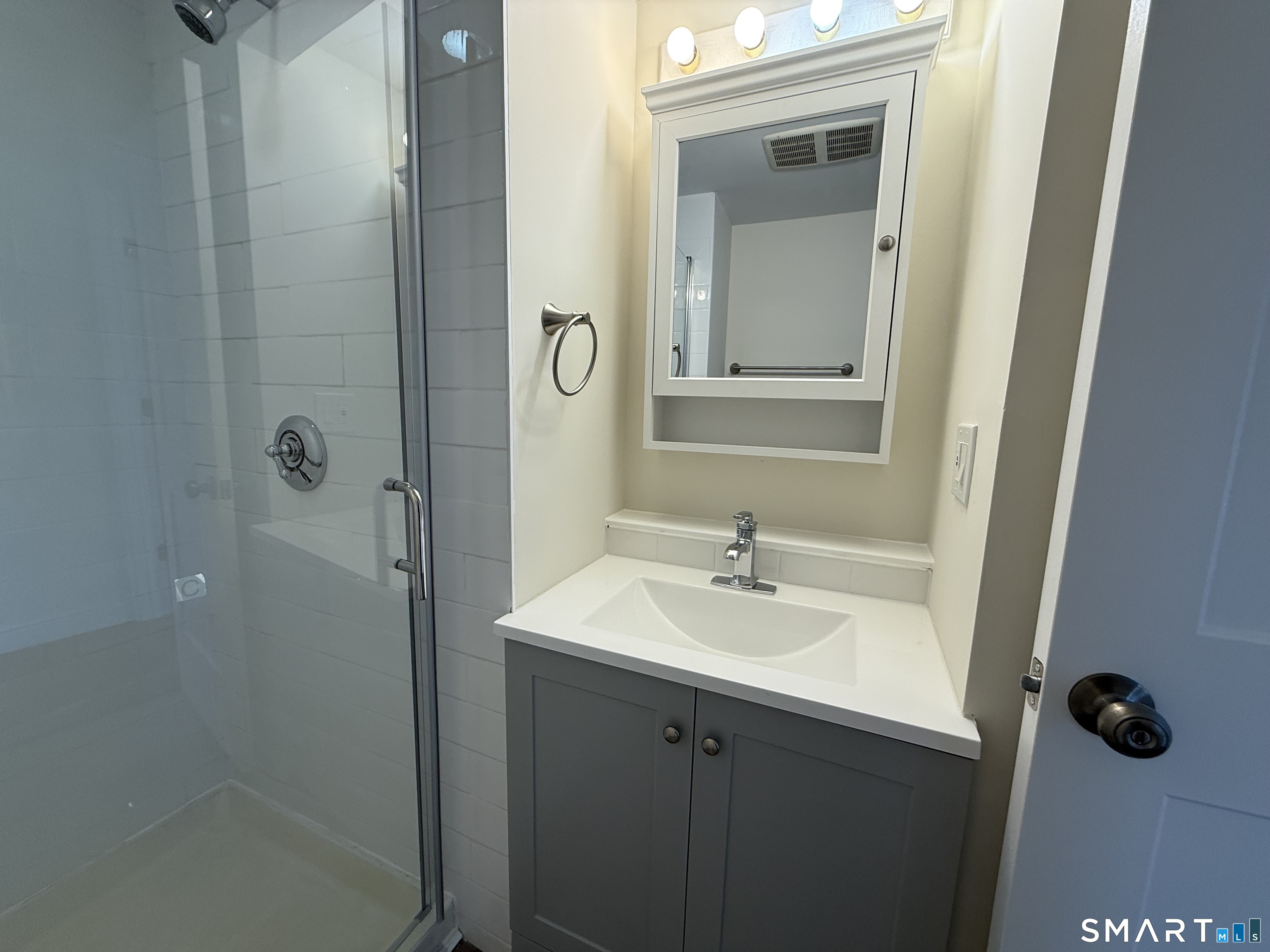 98 East Elm Street Torrington, CT 06790 - Photo 9 of 10 a bathroom with a sink a mirror and shower