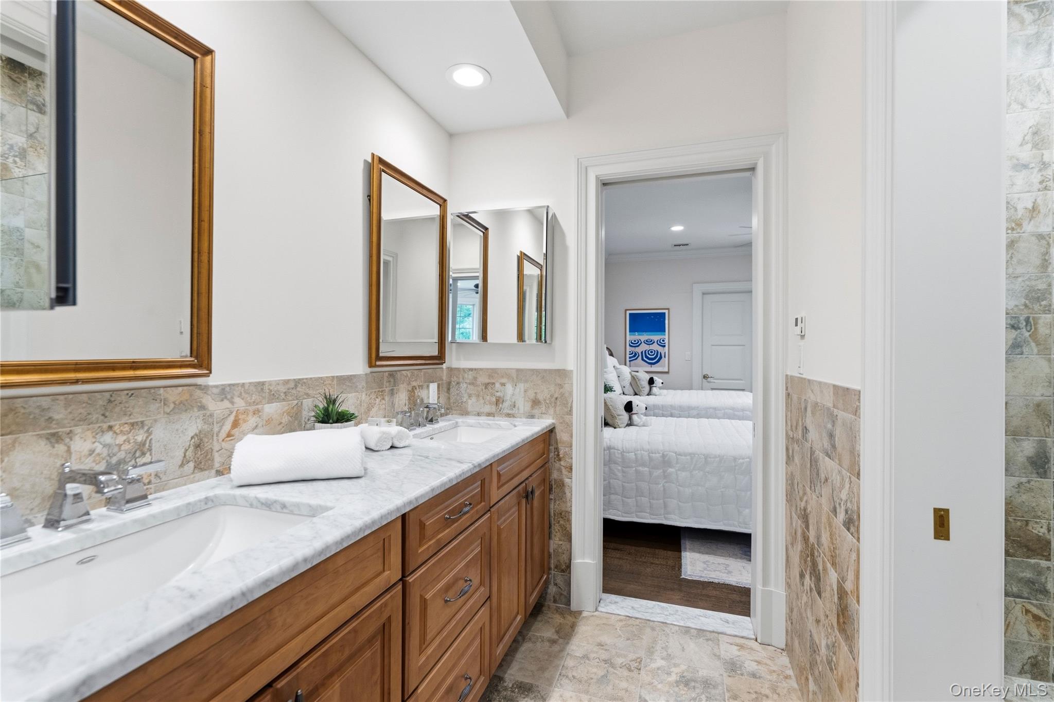 1960 Midlane Road South Syosset, NY 11791 - Photo 38 of 46 a en suite bathroom with a double vanity sink and a mirror