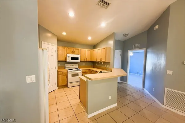 a kitchen with a stove a sink and a refrigerator