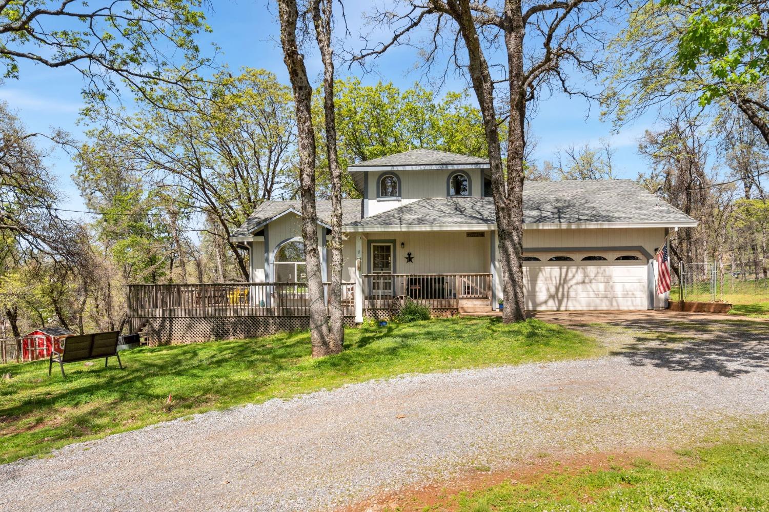 5271 Caprine Road Greenwood, CA 95635 - Photo 1 of 39 a view of a brick house with a yard and large tree