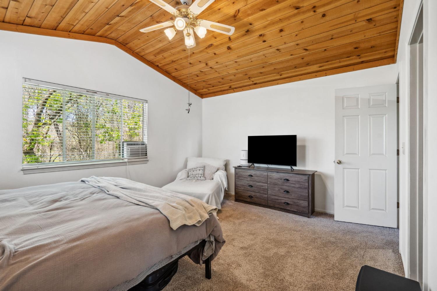 5271 Caprine Road Greenwood, CA 95635 - Photo 12 of 39 a bedroom with a bed and a television