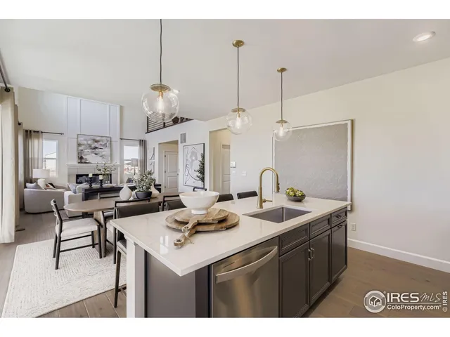 a kitchen with a sink a counter space and chairs