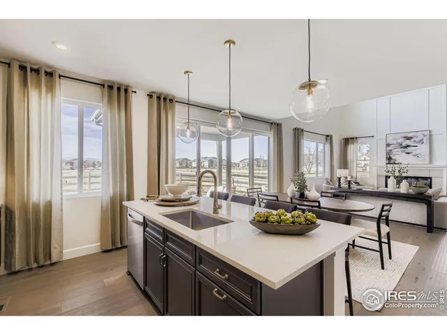 a kitchen with kitchen island granite countertop a sink cabinets and window