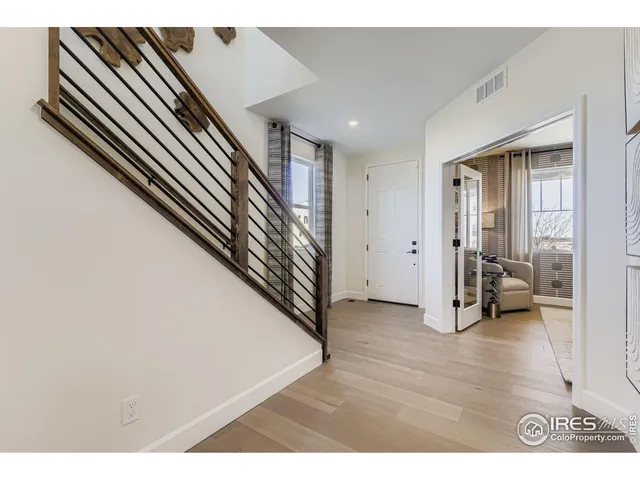 a hall way with furniture and entryway