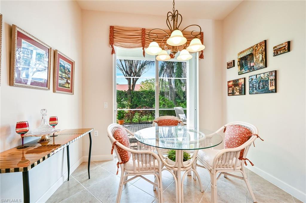 3359 Sandpiper Way Naples, FL 34109 - Photo 14 of 41 a dining room with furniture and chandelier