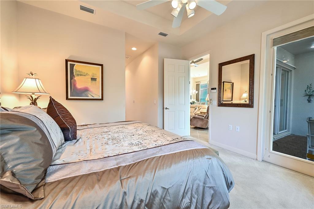 3359 Sandpiper Way Naples, FL 34109 - Photo 17 of 41 a bedroom with a large bed and a chandelier