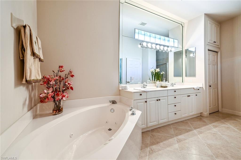 3359 Sandpiper Way Naples, FL 34109 - Photo 18 of 41 a bathroom with a bathtub sink and mirror