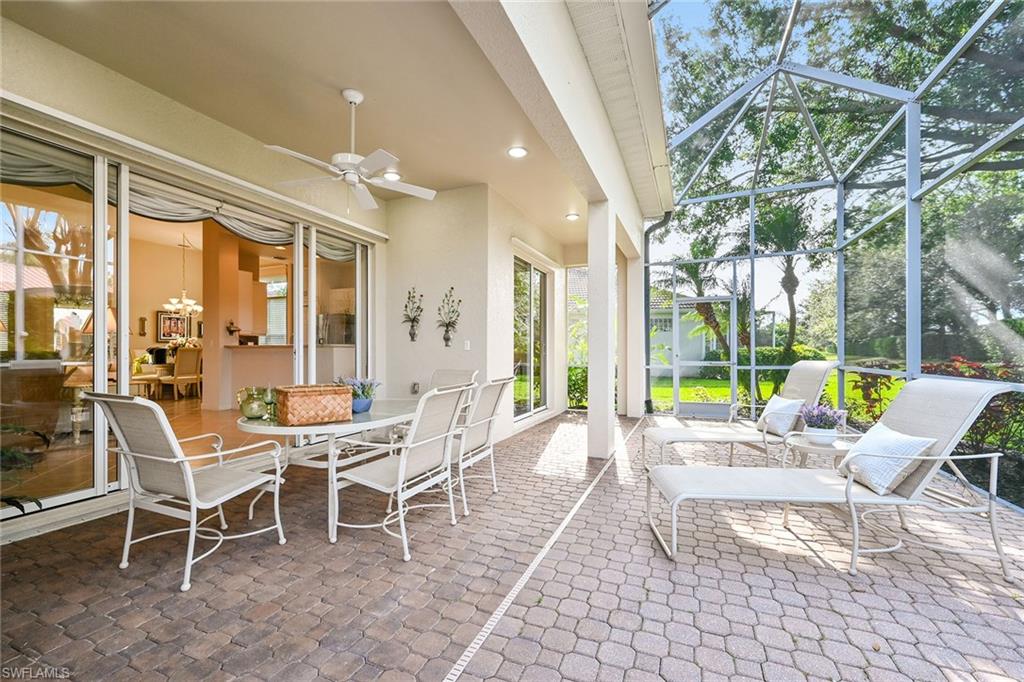 3359 Sandpiper Way Naples, FL 34109 - Photo 27 of 41 a view of a patio with a table and chairs