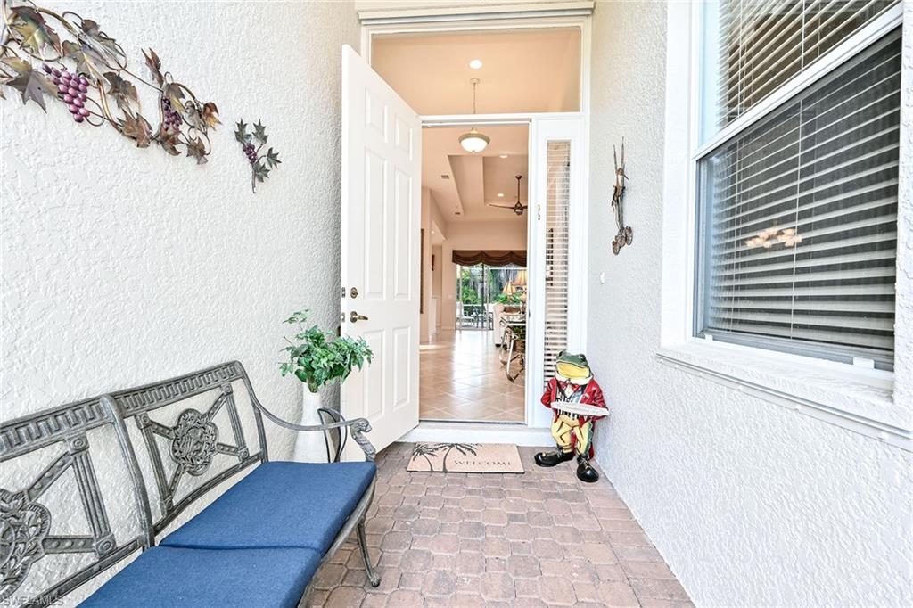 3359 Sandpiper Way Naples, FL 34109 - Photo 3 of 41 a view of a hallway with wooden floor and a potted plant