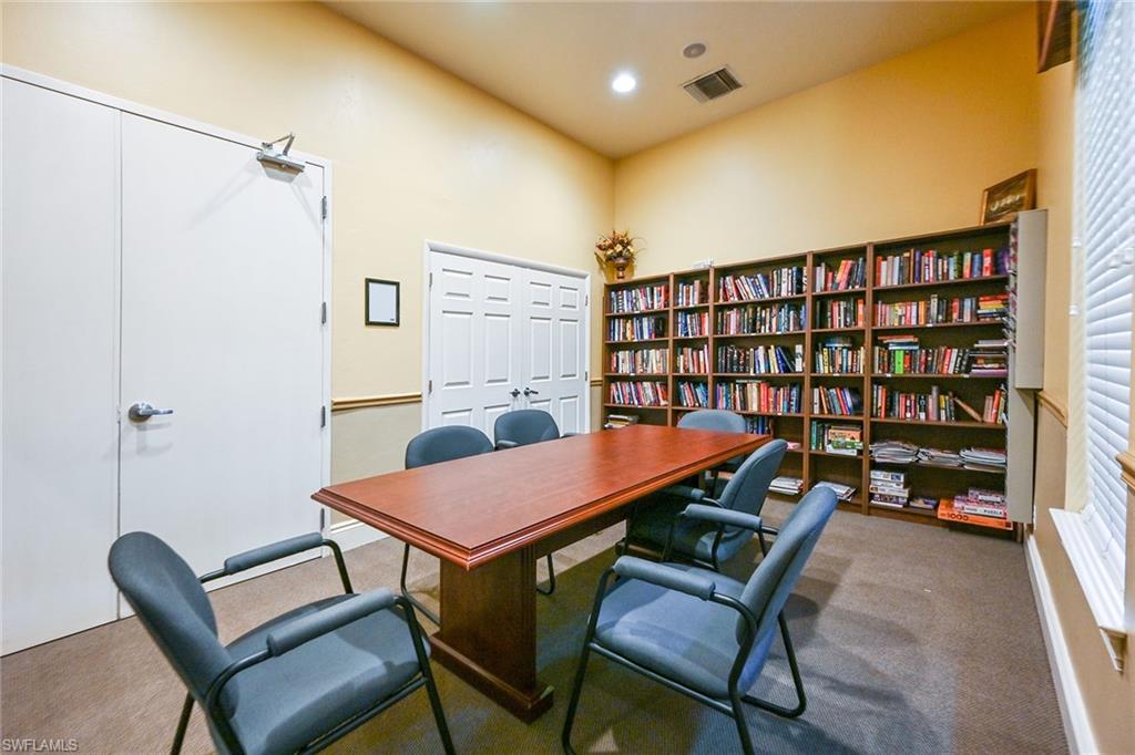 3359 Sandpiper Way Naples, FL 34109 - Photo 34 of 41 a reading room with furniture a rug and a book shelf
