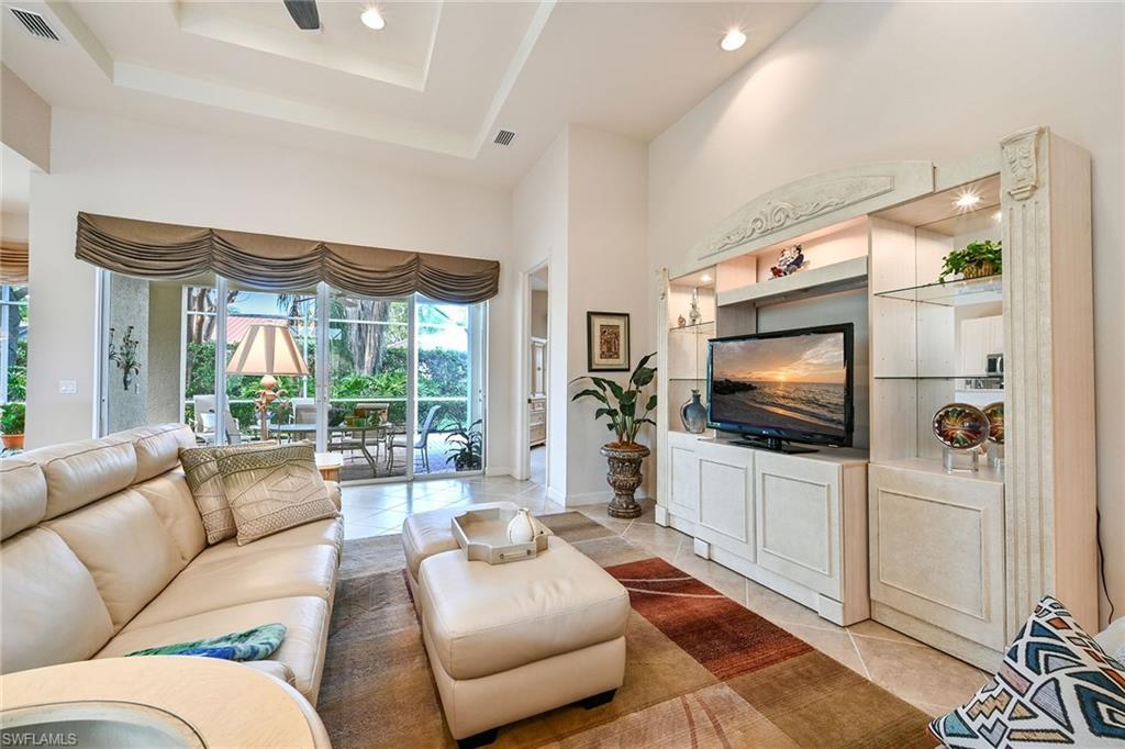 3359 Sandpiper Way Naples, FL 34109 - Photo 5 of 41 a living room with furniture and a flat screen tv