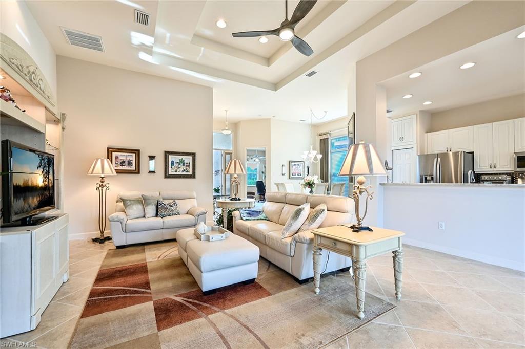 3359 Sandpiper Way Naples, FL 34109 - Photo 8 of 41 a living room with furniture and a flat screen tv