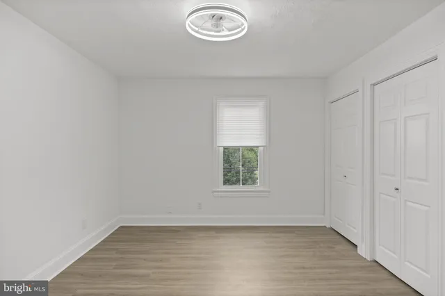 a bedroom with a large bed and a dresser