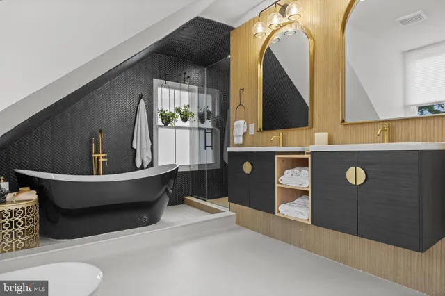 a spacious bathroom with a sink mirror and toilet