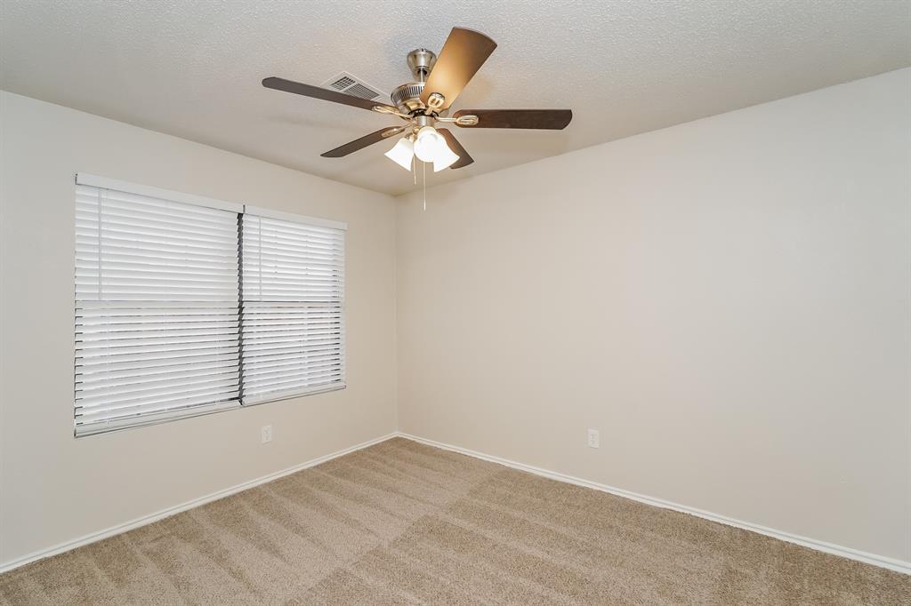 1334 Cedar Ridge Drive Lewisville, TX 75067 - Photo 13 of 16 an empty room with a window and a fan