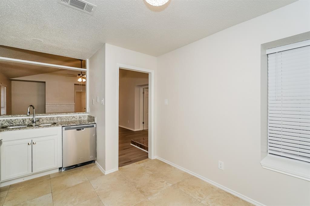 1334 Cedar Ridge Drive Lewisville, TX 75067 - Photo 7 of 16 a bathroom with a granite countertop sink a toilet and mirror