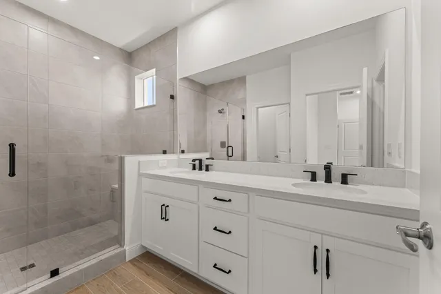 a bathroom with double sink and a mirror