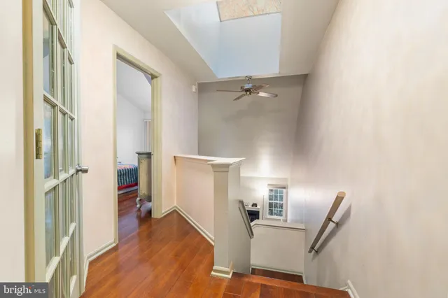 a view of a living room with furniture and wooden floor