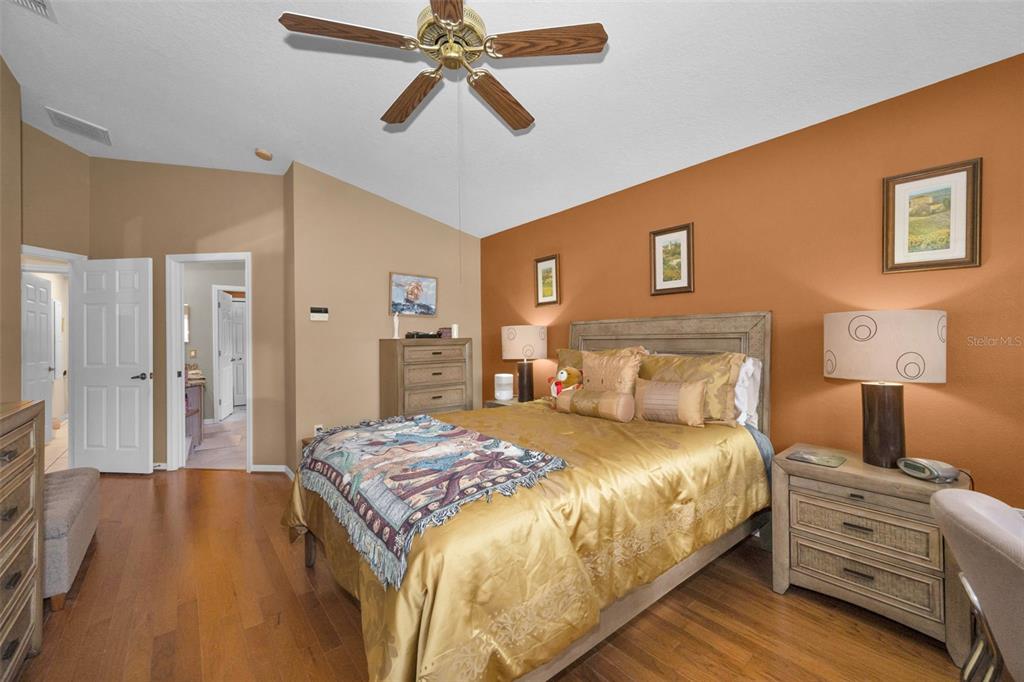 9630 Green Needle Drive New Port Richey, FL 34655 - Photo 13 of 23 a bedroom with a bed and wooden floor