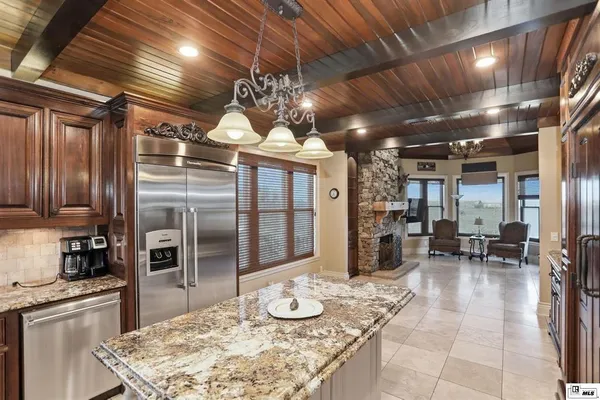 a kitchen with stainless steel appliances granite countertop a stove and refrigerator