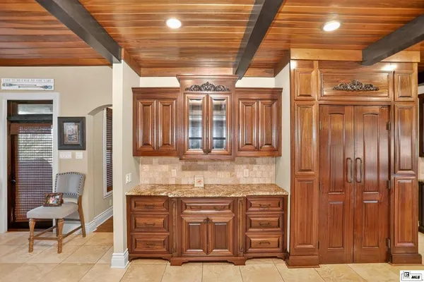 a kitchen with stainless steel appliances kitchen island granite countertop a refrigerator and a stove