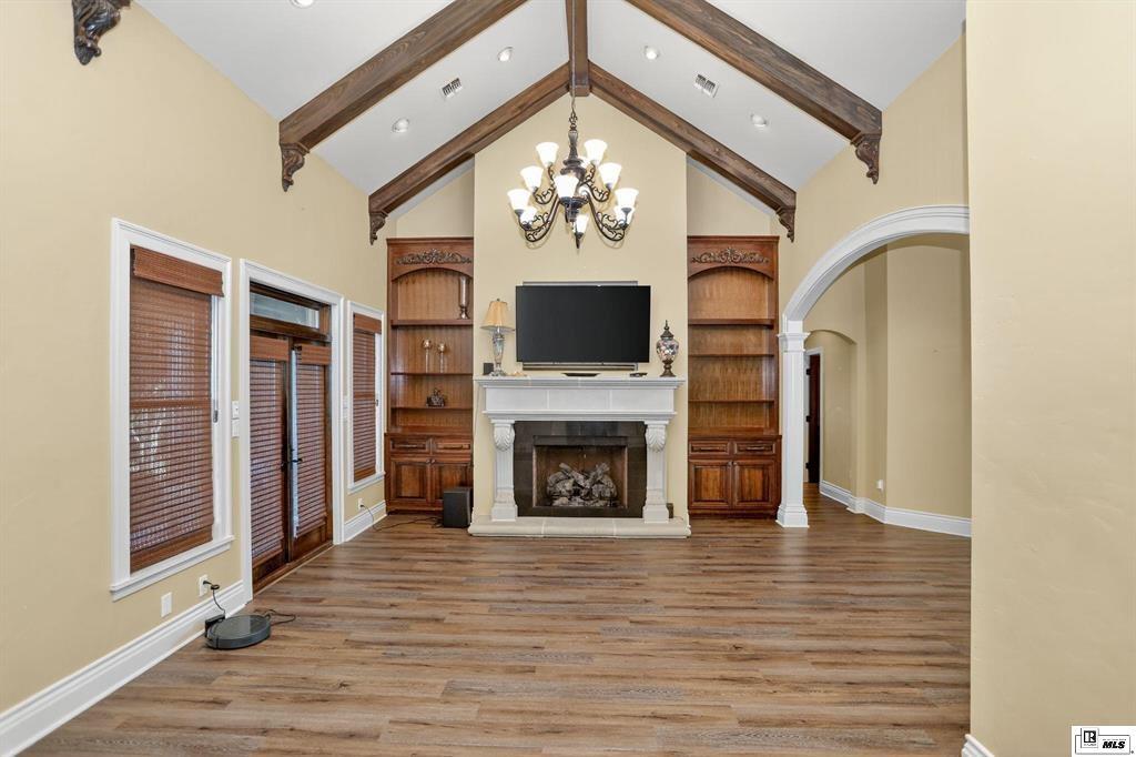 114 Apache Trail Delhi, LA 71232 - Photo 20 of 38 a view of a livingroom with a fireplace a ceiling fan wooden floors and a fireplace