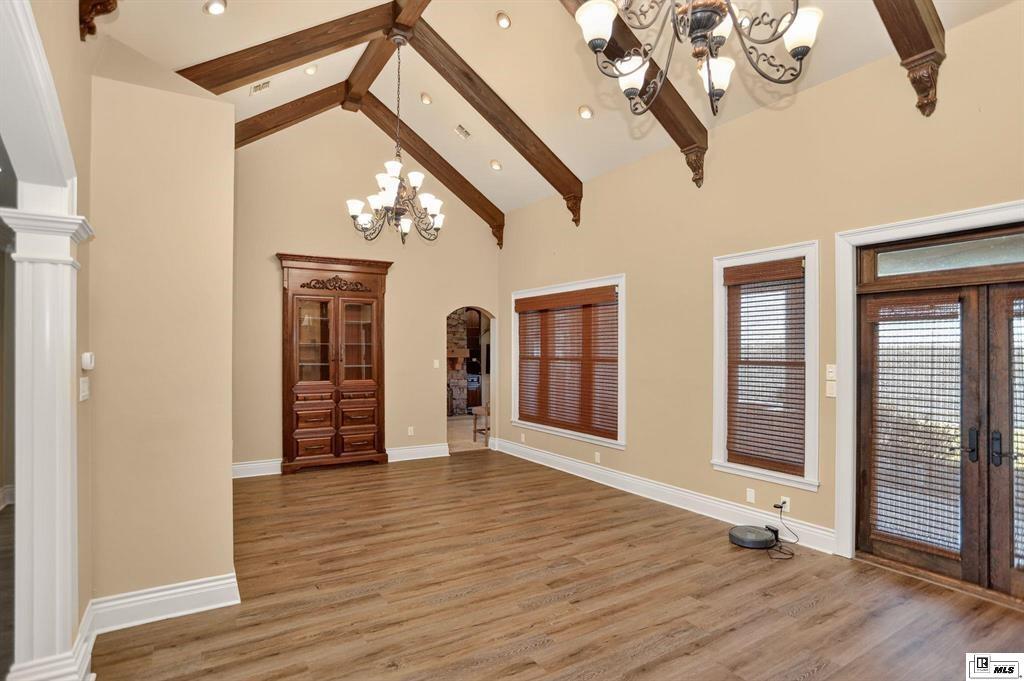 114 Apache Trail Delhi, LA 71232 - Photo 21 of 38 wooden floor in an empty room with a window