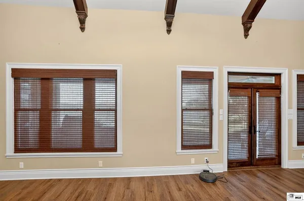 a view of a livingroom with wooden floor and a ceiling fan