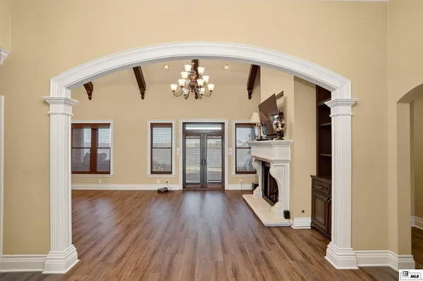 a view of a livingroom with wooden floor and a fireplace
