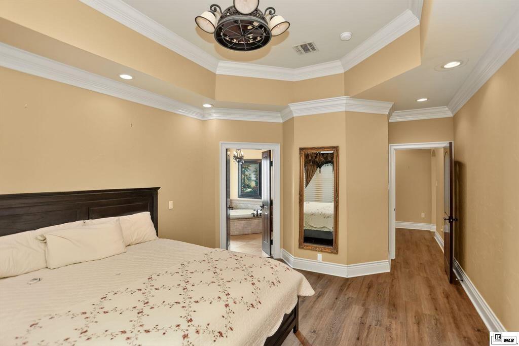 114 Apache Trail Delhi, LA 71232 - Photo 28 of 38 a bedroom with a bed and a flat screen tv